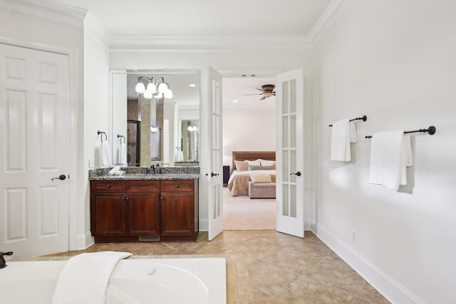 bathroom featuring french doors, vanity, crown molding, and tile patterned flooring