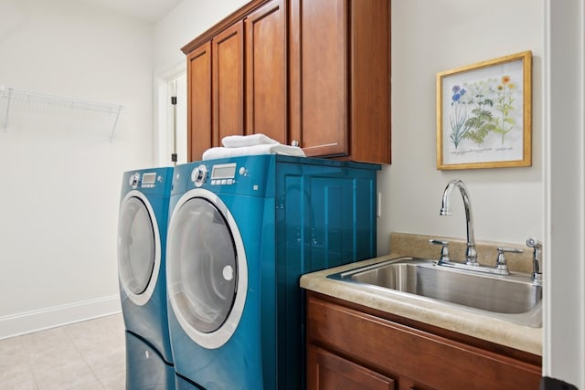 clothes washing area featuring cabinets, separate washer and dryer, sink, and light tile patterned floors