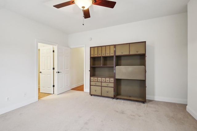 unfurnished bedroom featuring ceiling fan and light carpet