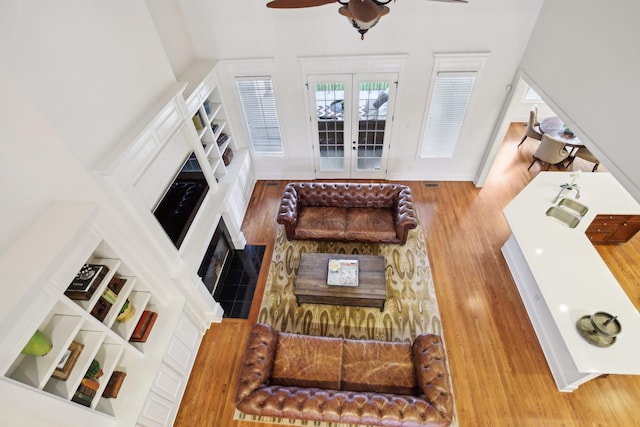 living room with hardwood / wood-style floors and ceiling fan