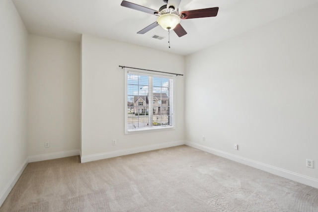 carpeted spare room featuring ceiling fan