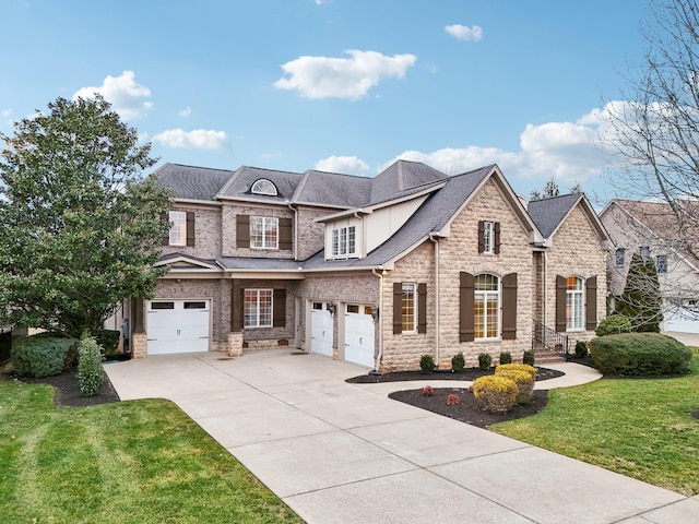 view of front of home featuring a garage and a front lawn