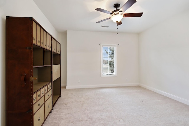 unfurnished bedroom featuring ceiling fan and light colored carpet