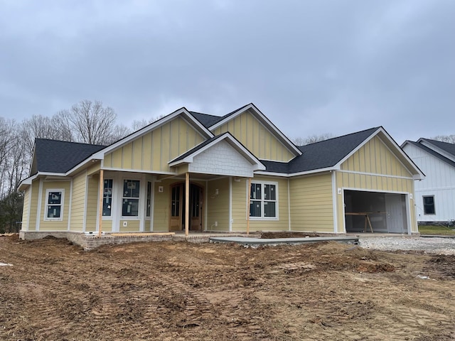 view of front of property featuring a porch, board and batten siding, and an attached garage