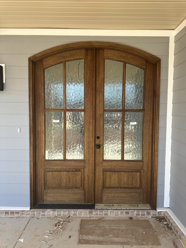 view of exterior entry featuring french doors