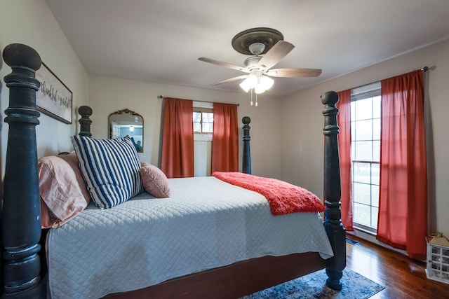 bedroom with dark hardwood / wood-style floors and ceiling fan