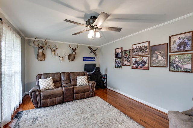 living room with ceiling fan, wood-type flooring, and crown molding