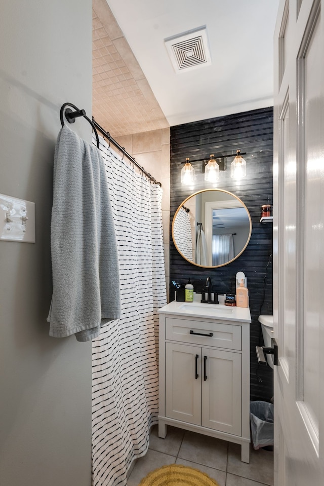 bathroom with a shower with curtain, vanity, and tile patterned floors