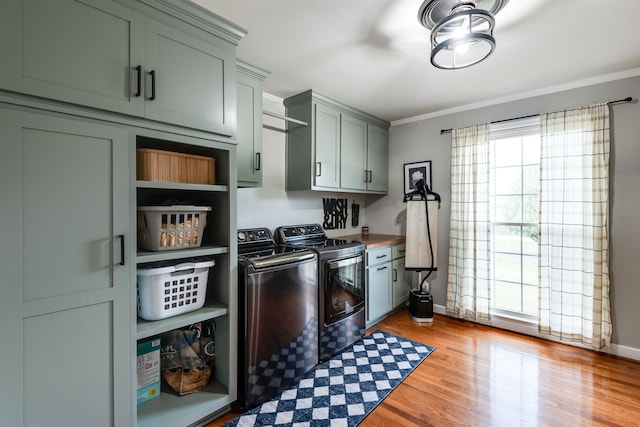 laundry room with cabinets, separate washer and dryer, light hardwood / wood-style flooring, and ornamental molding