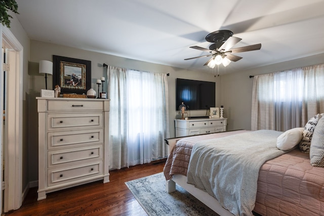 bedroom with ceiling fan and dark wood-type flooring