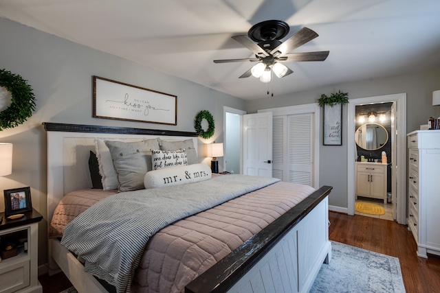 bedroom featuring ensuite bath, ceiling fan, and dark wood-type flooring