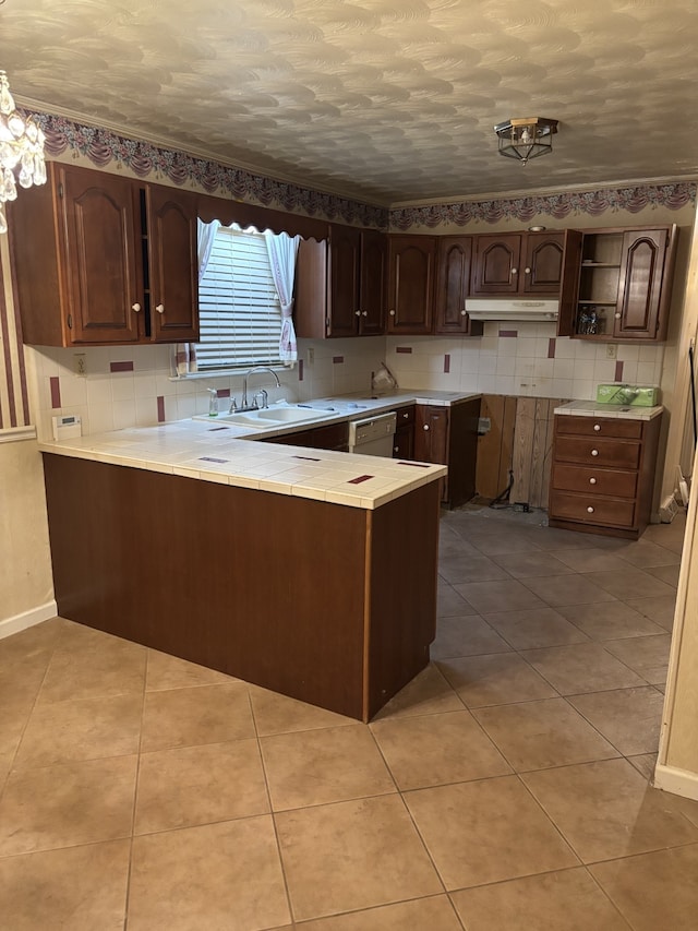 kitchen with dark brown cabinetry, dishwasher, sink, kitchen peninsula, and light tile patterned floors