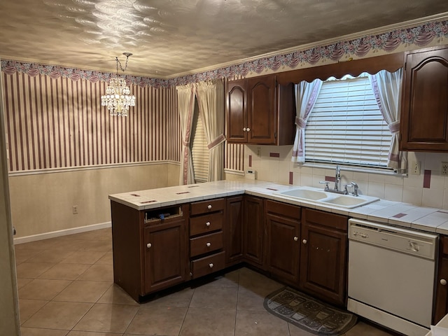 kitchen with kitchen peninsula, white dishwasher, sink, an inviting chandelier, and hanging light fixtures