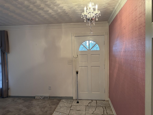 carpeted entryway featuring a chandelier, a textured ceiling, and ornamental molding