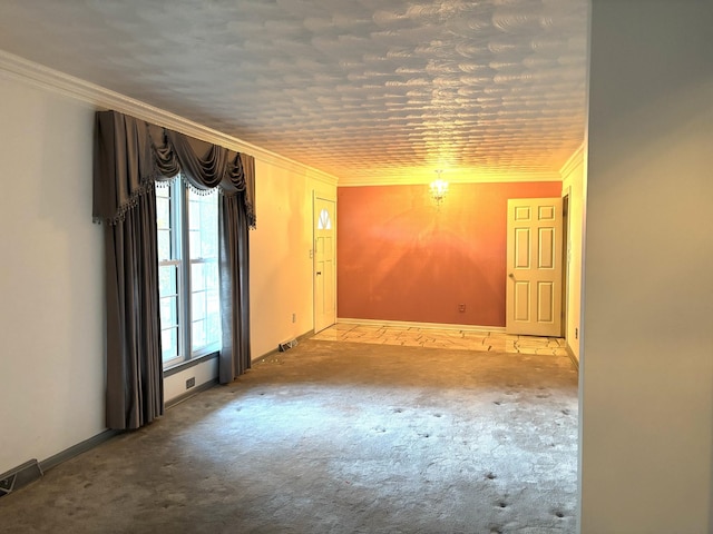 carpeted spare room with crown molding