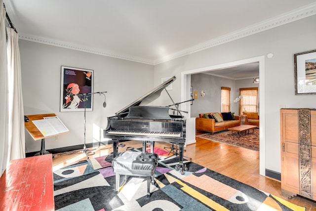 living area featuring wood-type flooring and crown molding