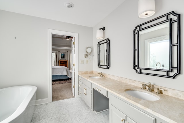 bathroom featuring a tub, ceiling fan, and vanity