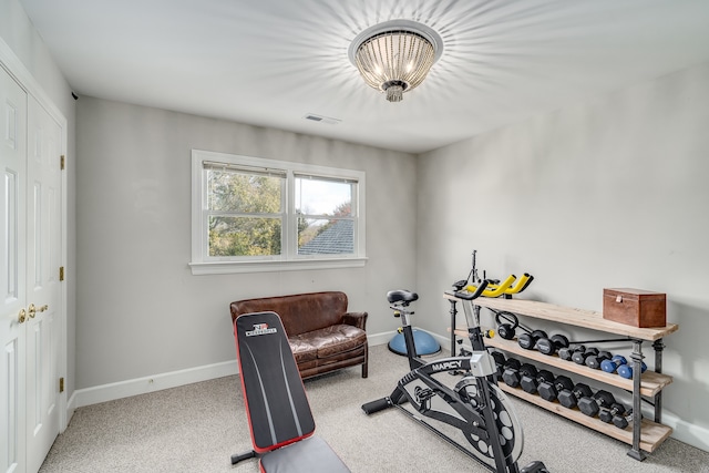 exercise room with light colored carpet