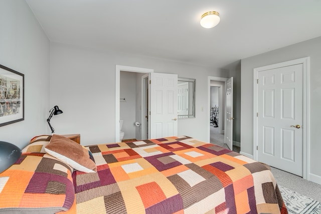 bedroom featuring carpet and connected bathroom