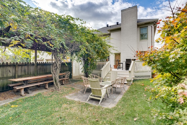 view of yard featuring a patio area and a wooden deck