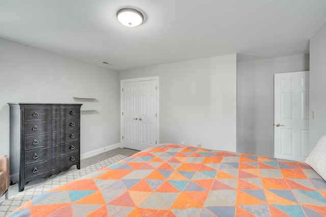 unfurnished bedroom with light colored carpet and a closet