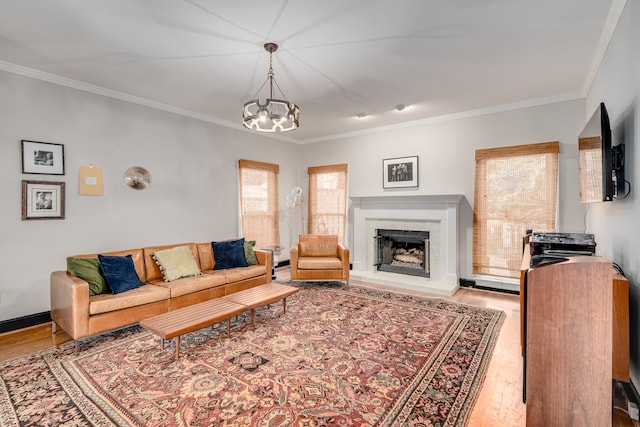 living room with a chandelier, light hardwood / wood-style floors, and crown molding