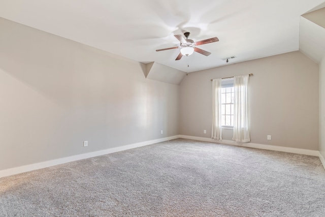 carpeted spare room with ceiling fan and lofted ceiling