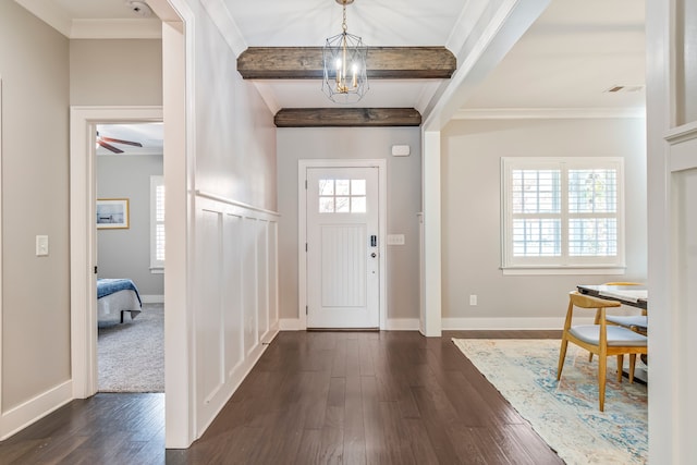 entryway with beamed ceiling, dark hardwood / wood-style floors, a healthy amount of sunlight, and a chandelier