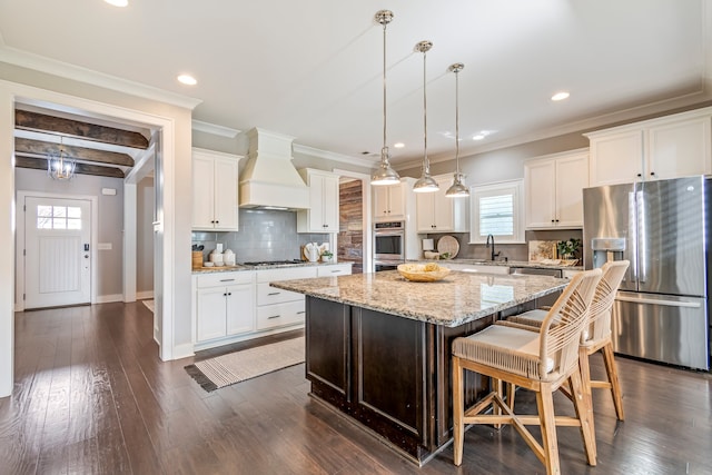 kitchen with custom range hood, stainless steel appliances, dark wood-type flooring, white cabinets, and a center island