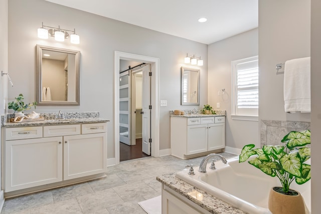 bathroom with vanity and a bath