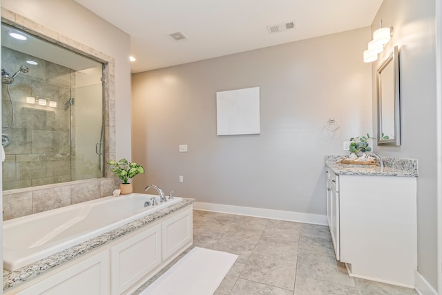 bathroom with vanity and separate shower and tub