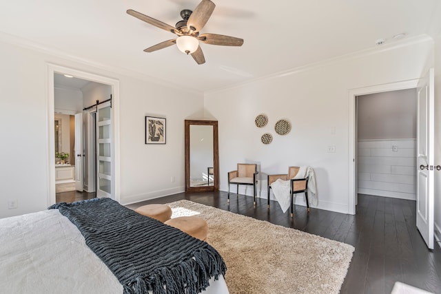 bedroom featuring ensuite bath, ceiling fan, dark wood-type flooring, a barn door, and crown molding