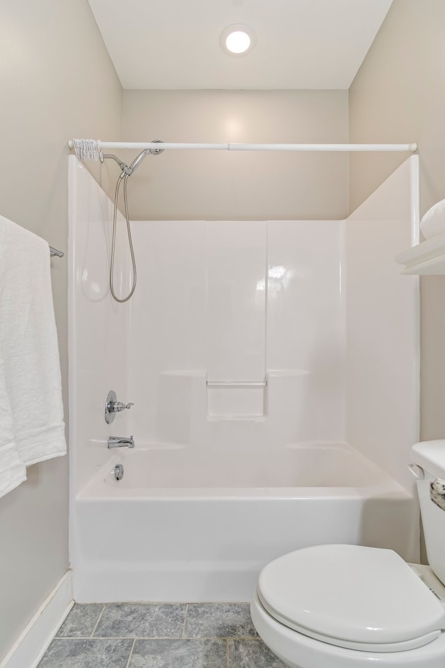 bathroom featuring shower / tub combination and toilet