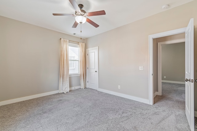 spare room featuring ceiling fan and light carpet