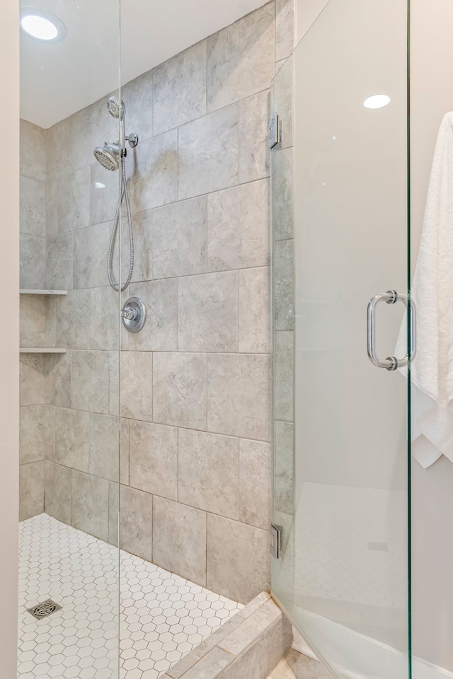 bathroom with a shower with shower door