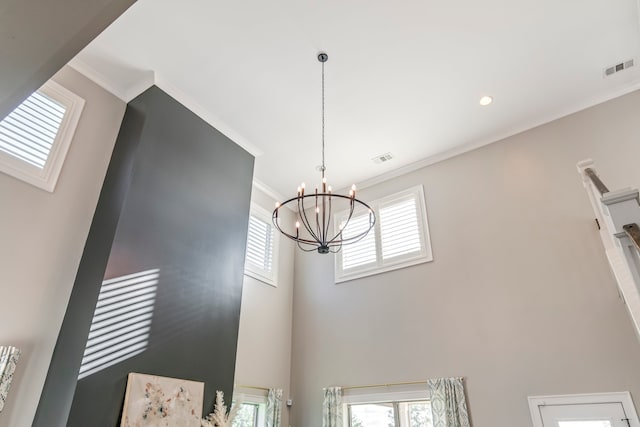 interior details featuring crown molding and a chandelier