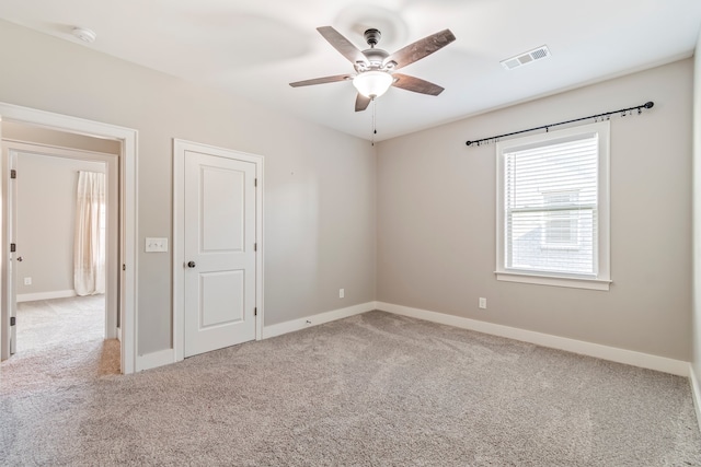 unfurnished room featuring light carpet and ceiling fan