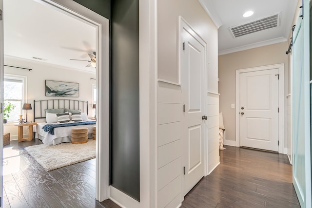 hall with dark hardwood / wood-style flooring and ornamental molding