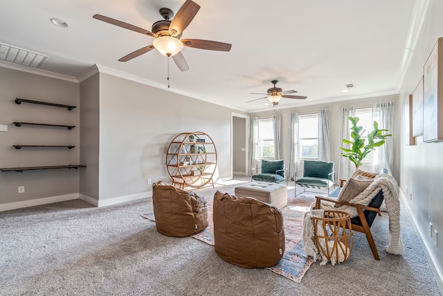 carpeted living room with ceiling fan and ornamental molding