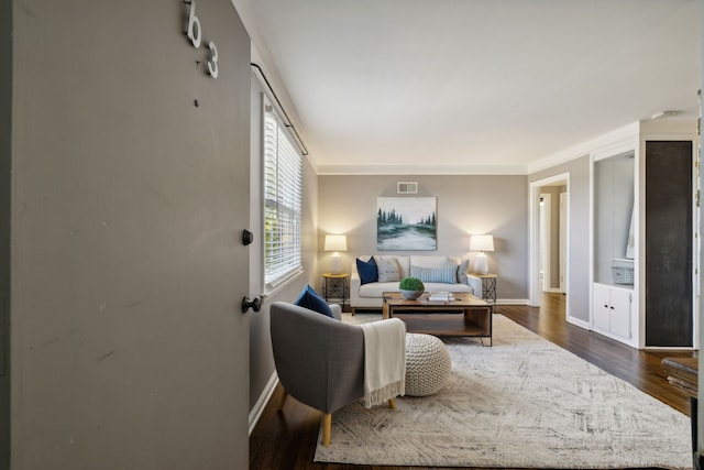 living room featuring dark hardwood / wood-style floors and ornamental molding