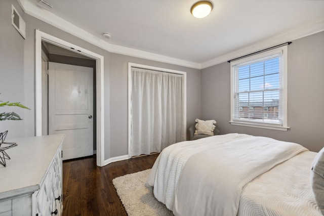 bedroom with dark hardwood / wood-style flooring and crown molding