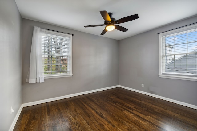 empty room featuring ceiling fan and dark hardwood / wood-style flooring