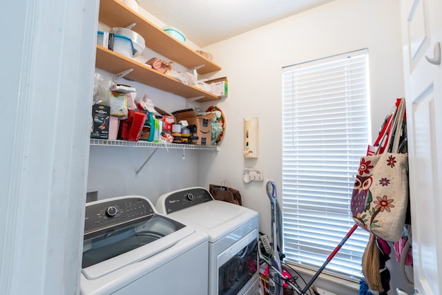 laundry room featuring a textured ceiling and separate washer and dryer