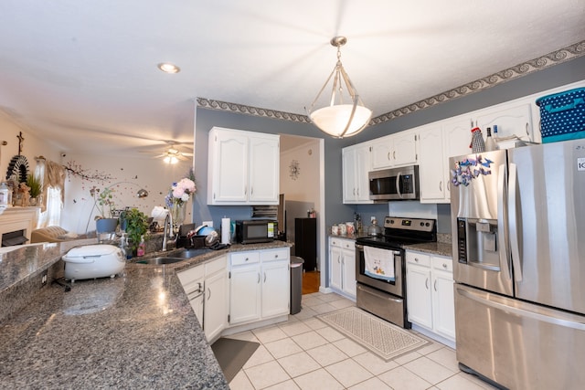 kitchen with white cabinets, decorative light fixtures, stainless steel appliances, and sink