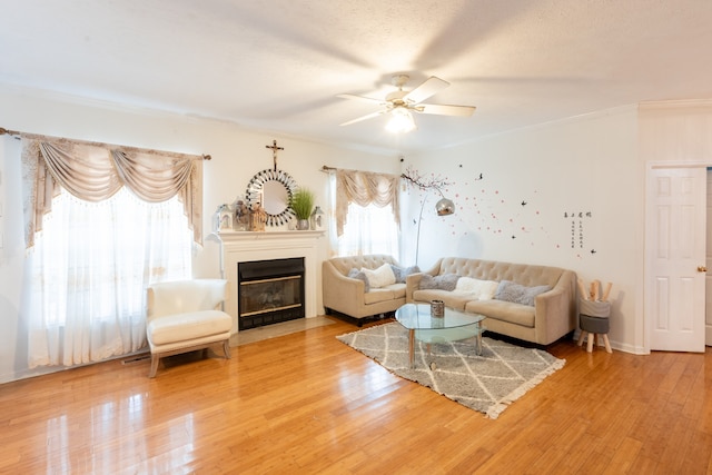 living room featuring a wealth of natural light, ceiling fan, and hardwood / wood-style flooring