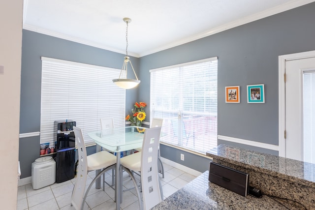 dining area featuring crown molding and light tile patterned floors