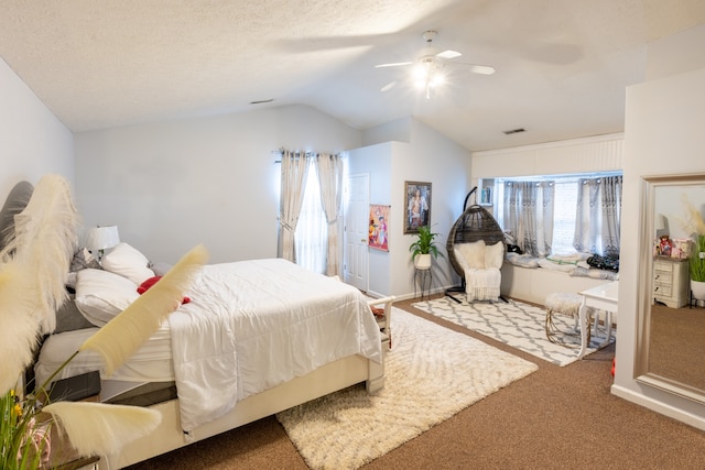 bedroom featuring a textured ceiling, ceiling fan, carpet floors, and vaulted ceiling