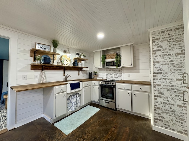 kitchen featuring dark wood-type flooring, butcher block counters, sink, appliances with stainless steel finishes, and white cabinets