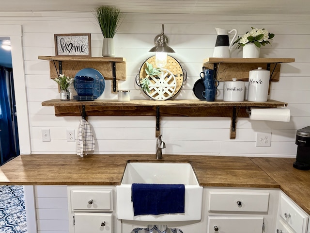 kitchen with white cabinetry and sink