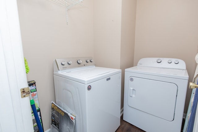 laundry room featuring dark wood-type flooring and independent washer and dryer